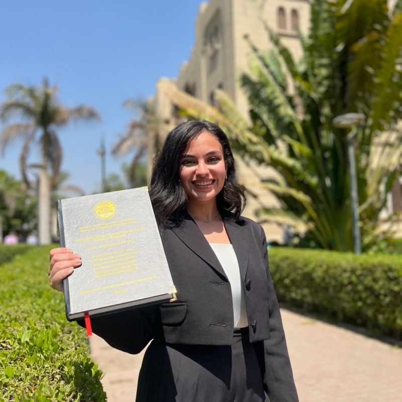 Nathalie Tawadros holding her thesis.